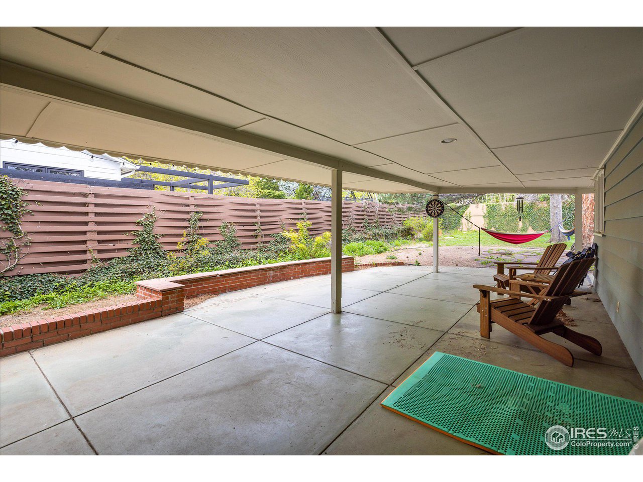 2855 4th Street Boulder, CO 80304 - Photo 23 of 37 a view of a patio with a table and chairs next to a yard