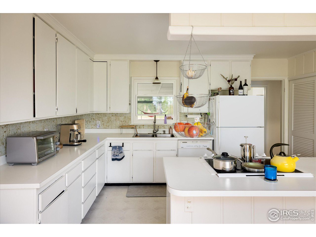 2855 4th Street Boulder, CO 80304 - Photo 9 of 37 a kitchen with a sink dishwasher stove and white cabinets