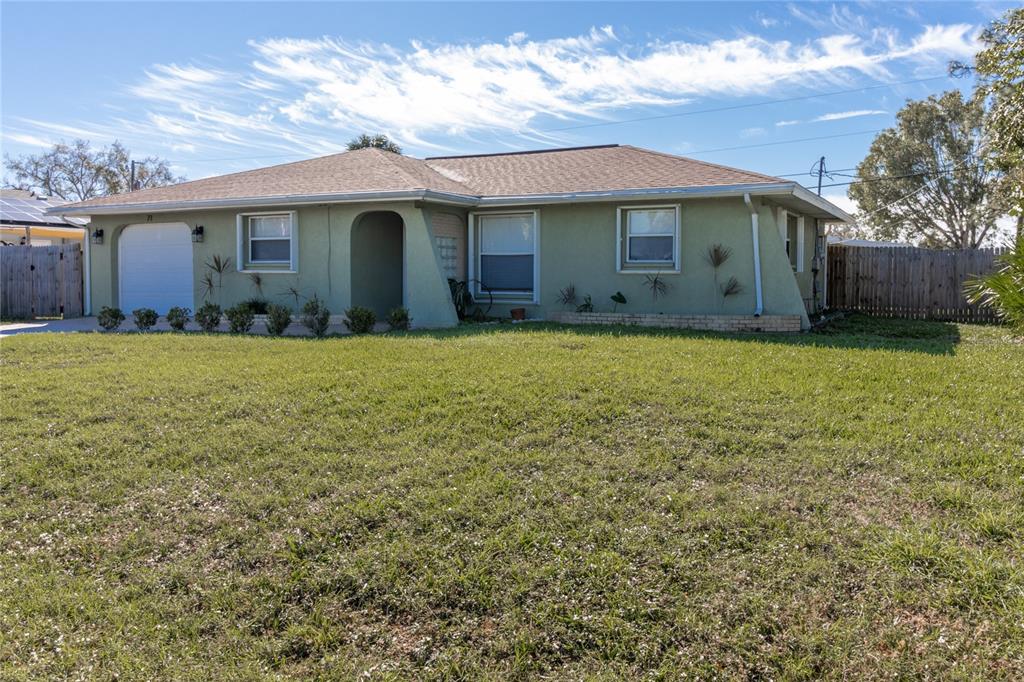71 Abalone Road Venice, FL 34293 - Photo 1 of 1 a front view of a house with yard and green space