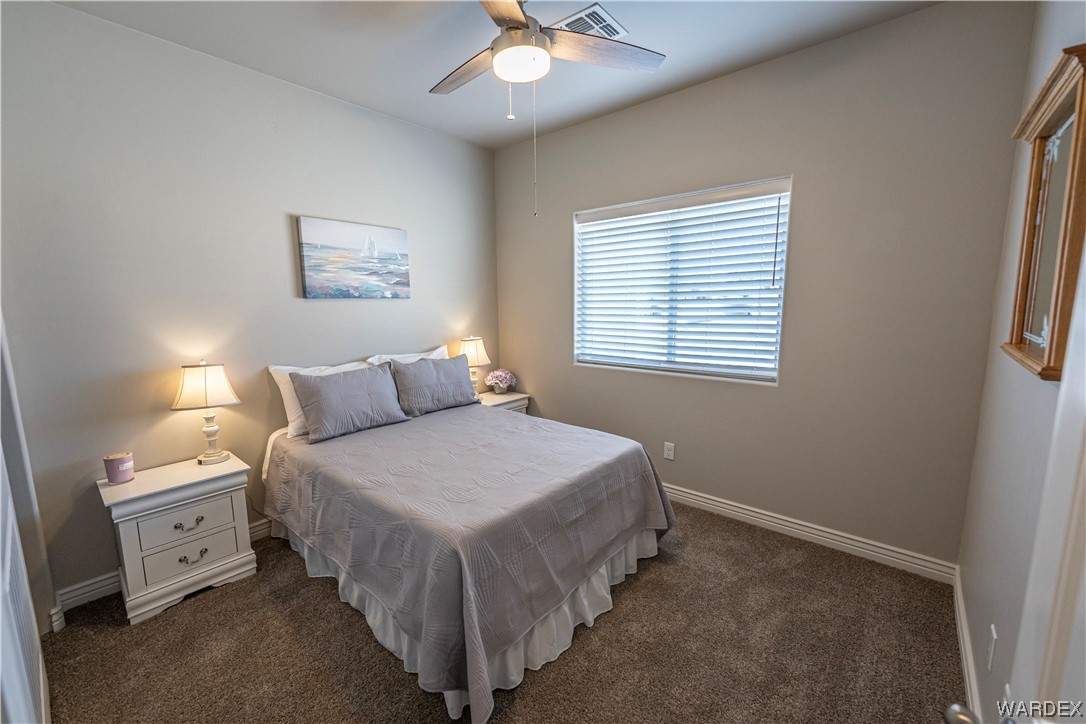 3550 North Kenneth Road Kingman, AZ 86409 - Photo 12 of 41 a bedroom with a bed and a chandelier