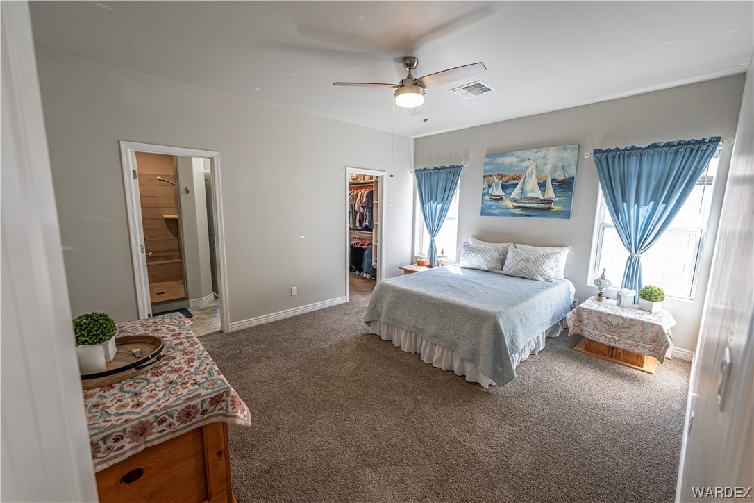 3550 North Kenneth Road Kingman, AZ 86409 - Photo 13 of 41 a bedroom with a bed and a chandelier