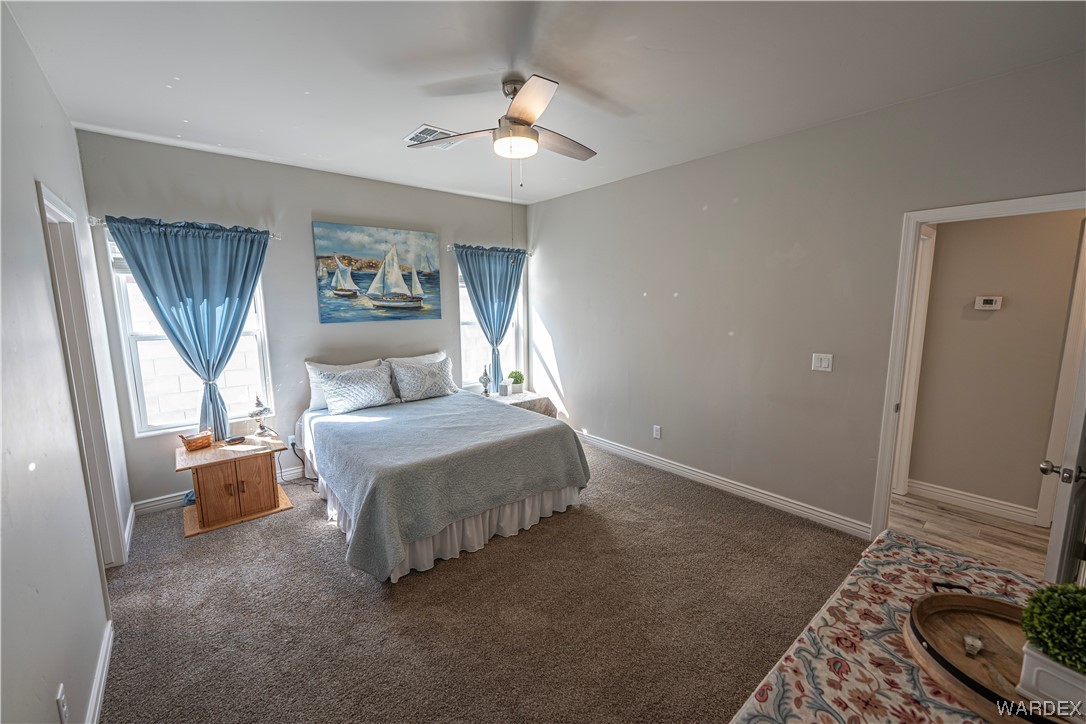 3550 North Kenneth Road Kingman, AZ 86409 - Photo 14 of 41 a bedroom with a bed and a chandelier