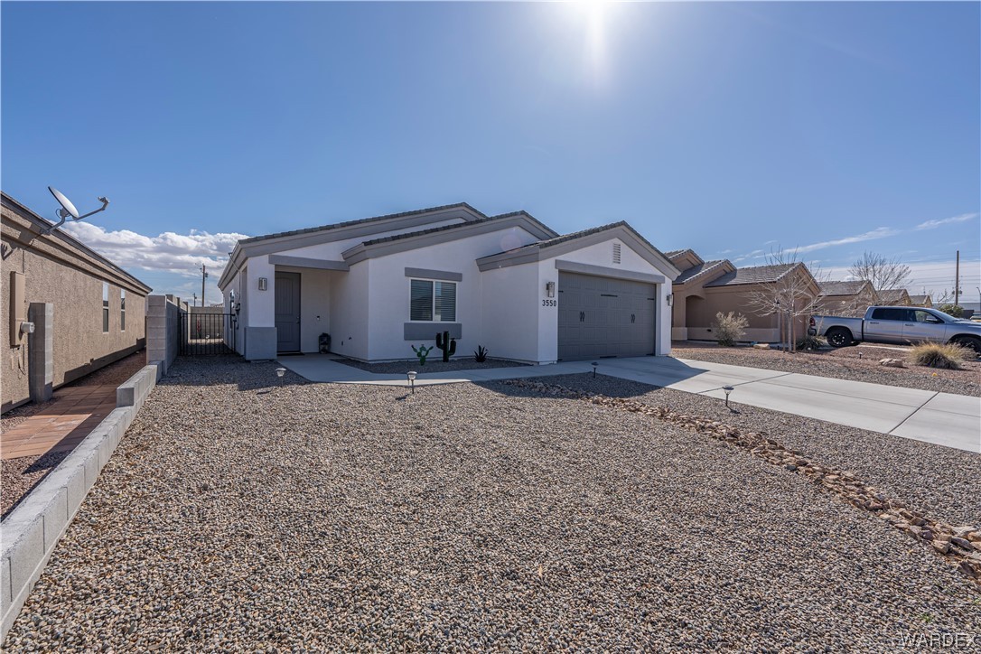 3550 North Kenneth Road Kingman, AZ 86409 - Photo 3 of 41 a view of a house with a yard and car parked