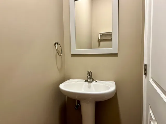 a bathroom with a sink and mirror