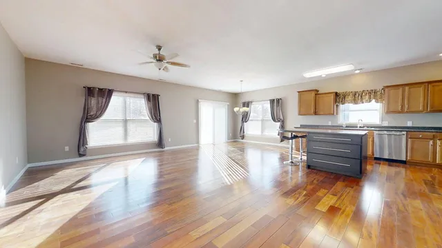 a view of a living room a kitchen and a wooden floor