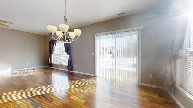 a view of a room with wooden floor