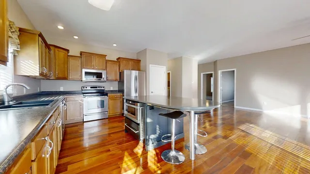 a kitchen with stainless steel appliances a refrigerator and a stove top oven