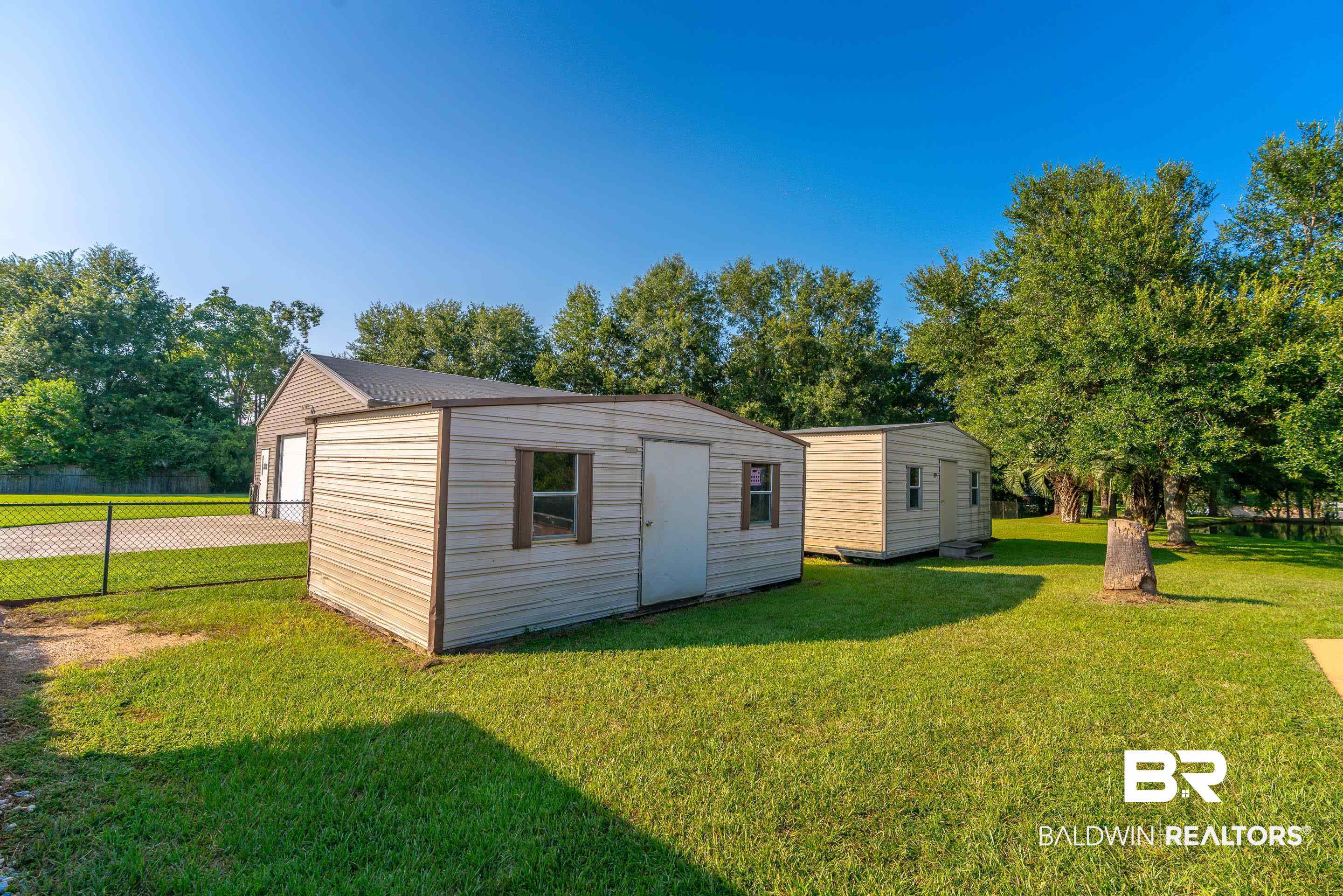 9477 Deerfield Drive Irvington, AL 36544 - Photo 49 of 58 View of outbuilding with a garage and a lawn