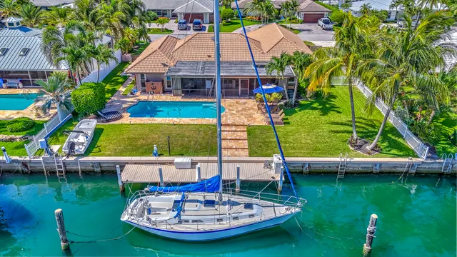 a front view of a house with a yard and potted plants
