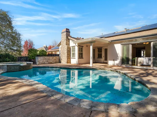 a view of a swimming pool with a yard
