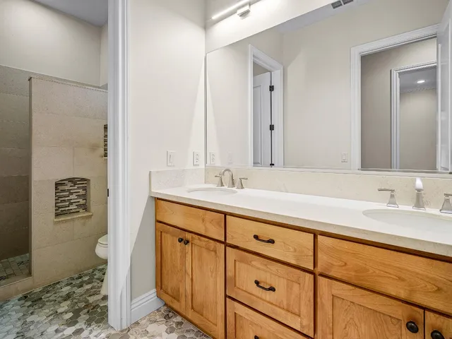 a spacious bedroom with a bed chairs and a fireplace