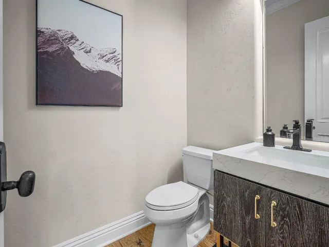 a spacious bedroom with a bed and wooden floor