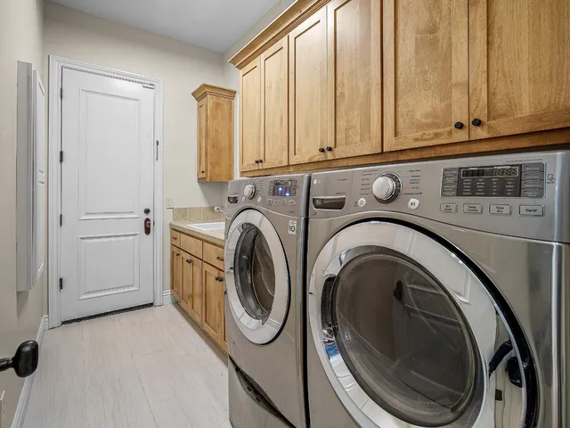 a bathroom with a tub a sink and a large mirror