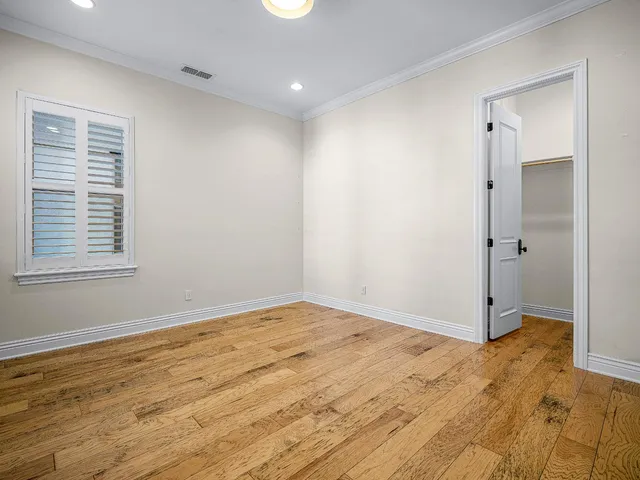 a view of a house with a big yard and large trees