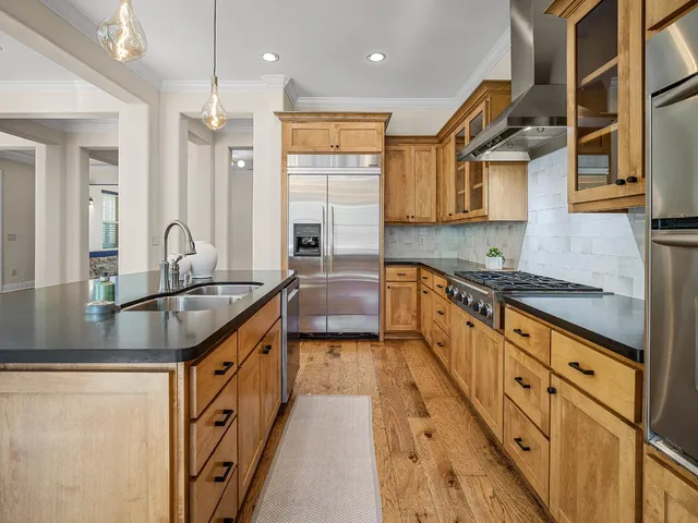 a kitchen with a stove a sink and a refrigerator
