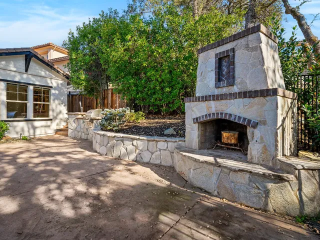 a living room with furniture a large window and a fireplace