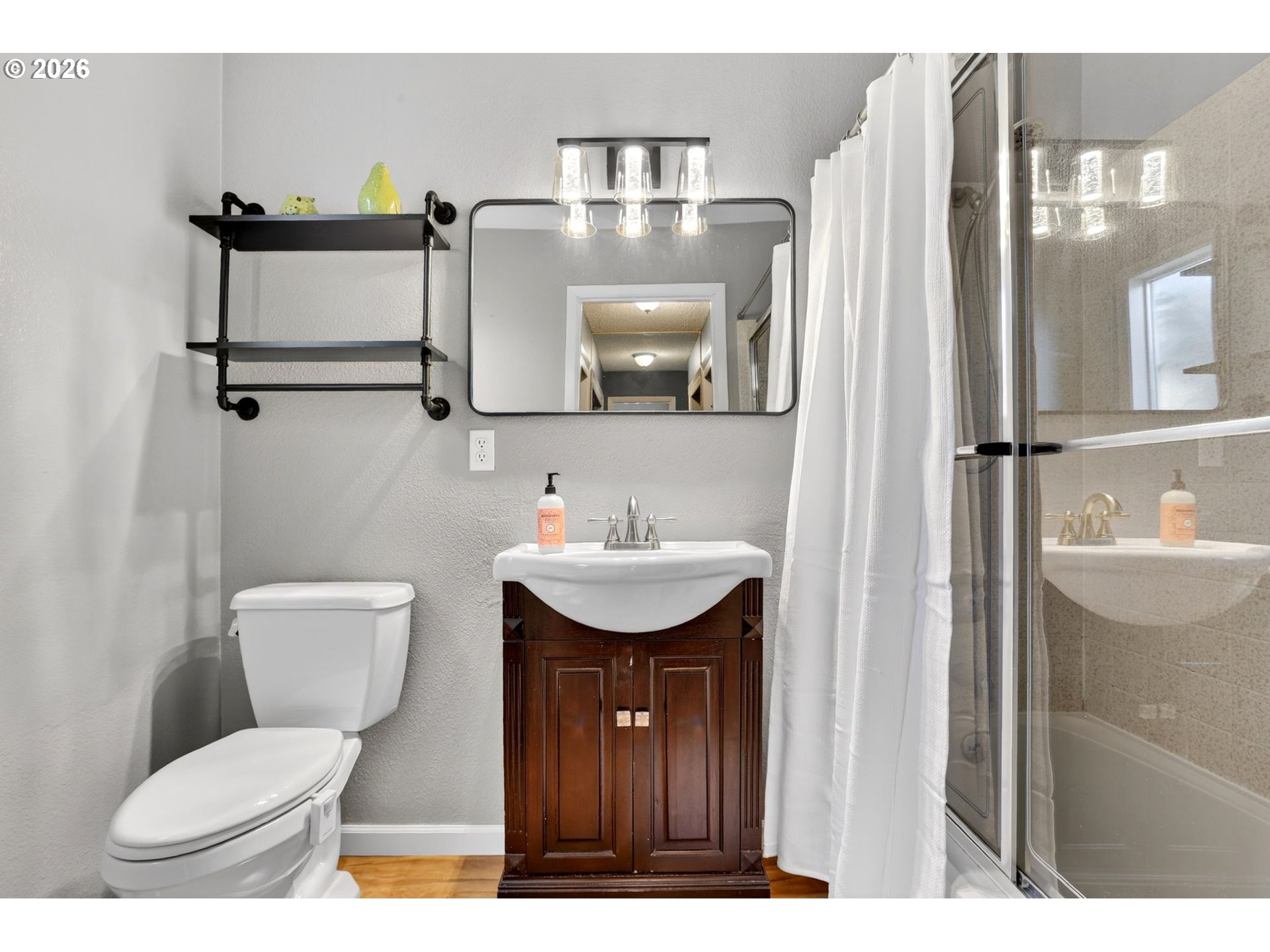 1776 Southeast 114th Place Portland, OR 97216 - Photo 33 of 47 a bathroom with a toilet a sink and mirror