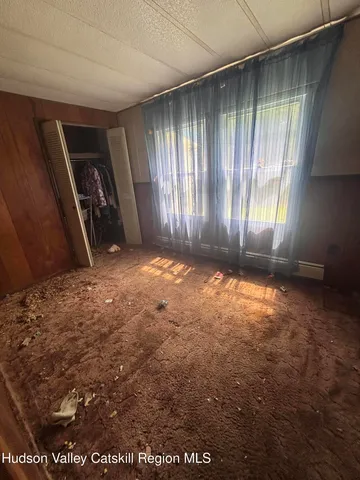 a view of a field with trees in the background