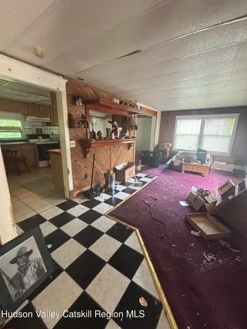 a room with lots of white furniture and a rug