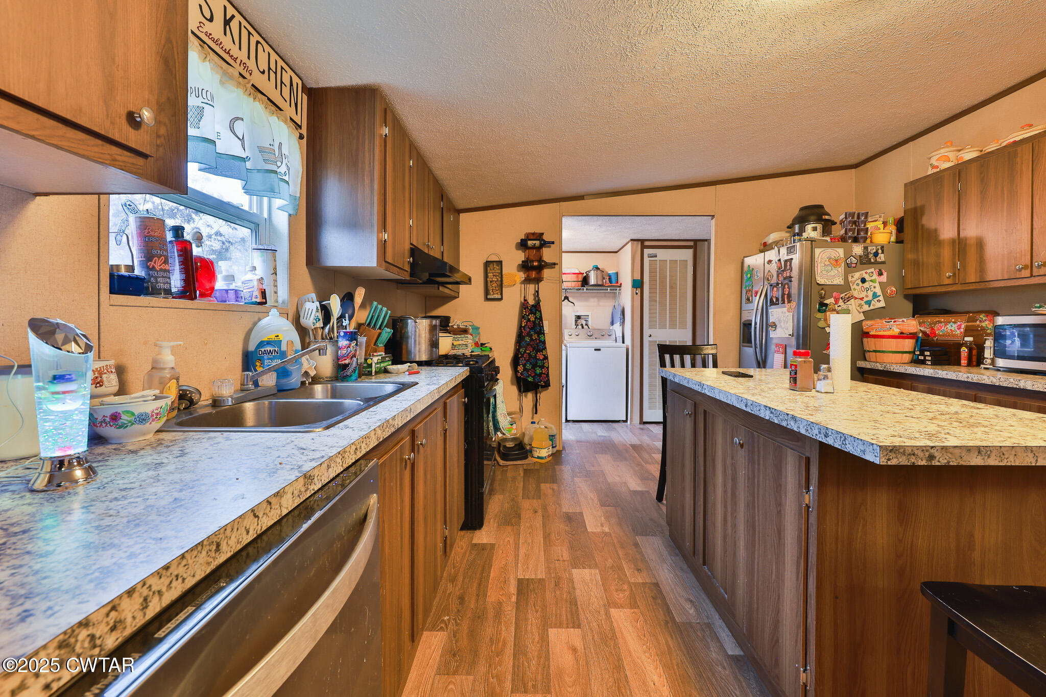 4532 Old State Rte 22 Gleason, TN 38229 - Photo 11 of 34 a kitchen with stainless steel appliances granite countertop sink stove top oven and cabinets