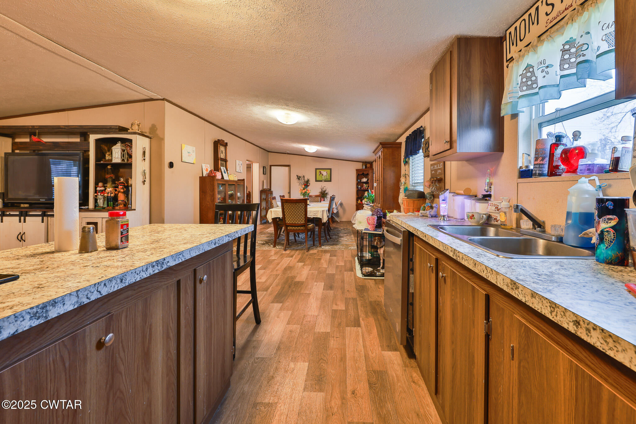 4532 Old State Rte 22 Gleason, TN 38229 - Photo 12 of 34 a kitchen with stainless steel appliances granite countertop lots of counter top space and wooden floor