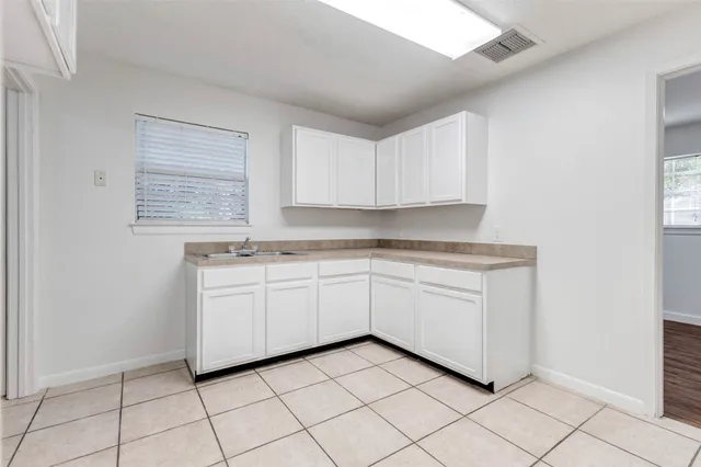 a kitchen with granite countertop white cabinets and white appliances