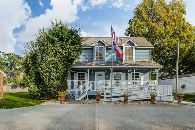a front view of a house with garden and porch