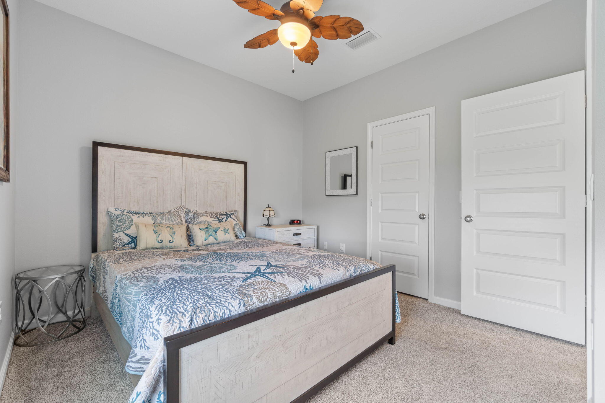 38 Silverthorn Street Freeport, FL 32439 - Photo 25 of 42 a bedroom with a bed and a chandelier