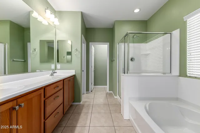 a spacious bathroom with a bathtub sink and mirror