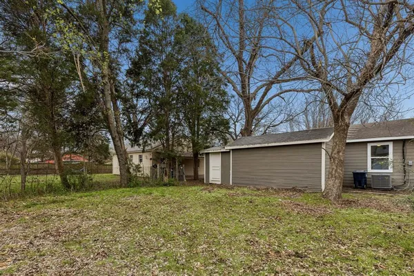 a house that has a tree in front of it