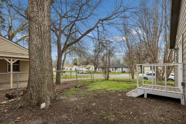 a view of a yard with large trees