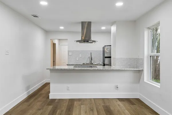 a view of a kitchen with a sink stainless steel appliances and cabinets