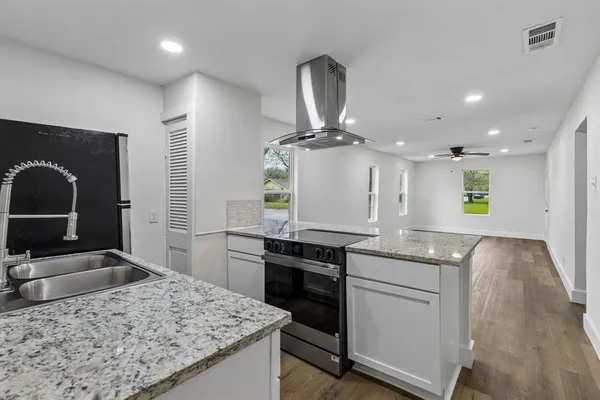 a kitchen with a sink stove and refrigerator