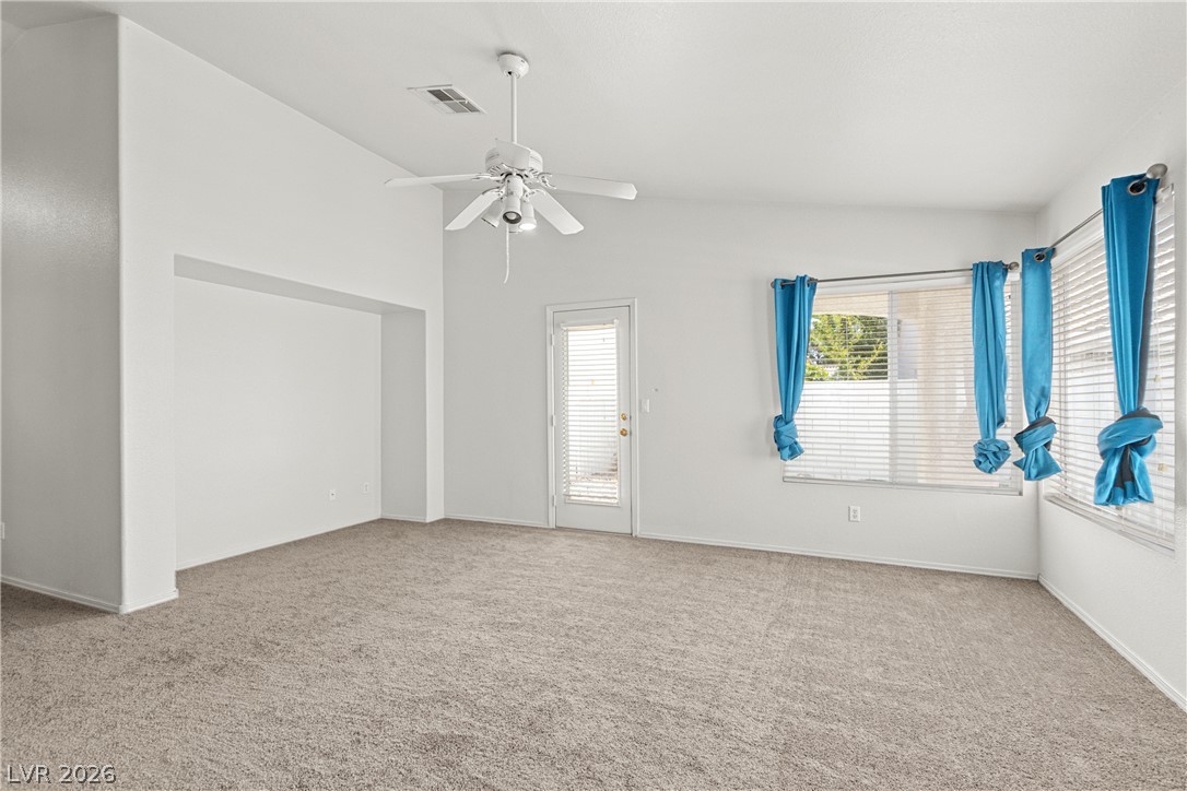 1815 Stablegate Avenue Henderson, NV 89012 - Photo 15 of 28 A well-lit living area features comfortable carpeting and convenient outdoor access.