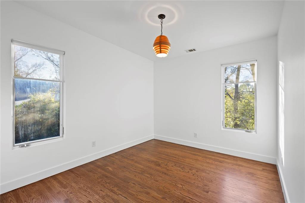 935 Custer Avenue Southeast Atlanta, GA 30316 - Photo 14 of 24 a view of an empty room with wooden floor and a window
