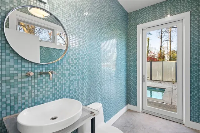 a bathroom with a sink a bathtub and shower