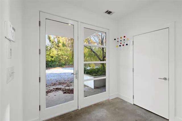 a view of a livingroom with wooden floor and a porch
