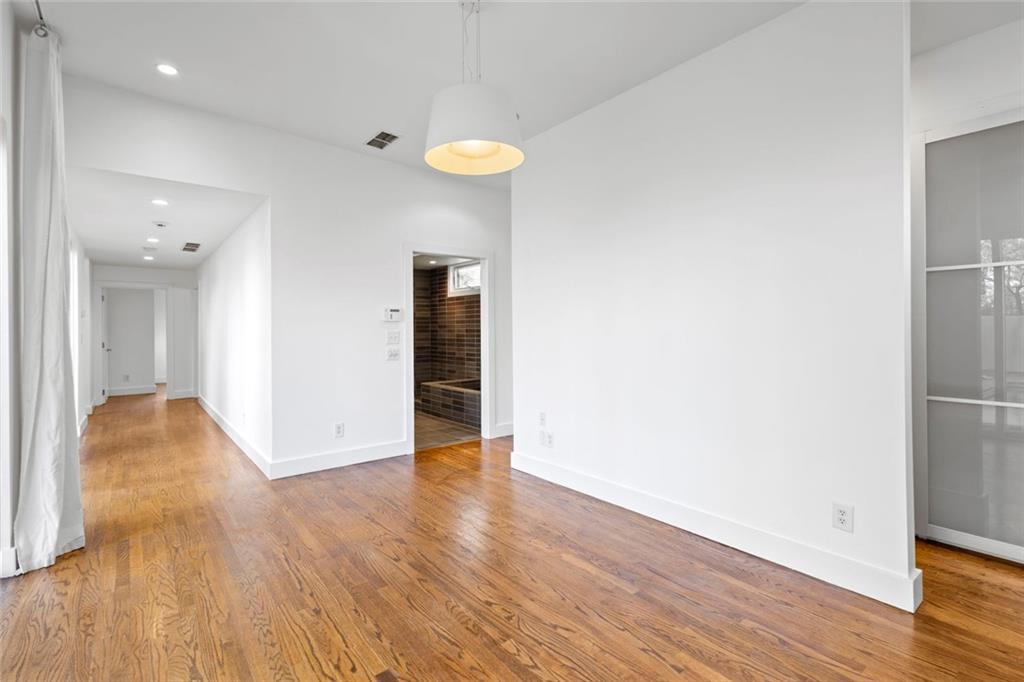 935 Custer Avenue Southeast Atlanta, GA 30316 - Photo 8 of 24 a view of an empty room with wooden floor and a bathroom