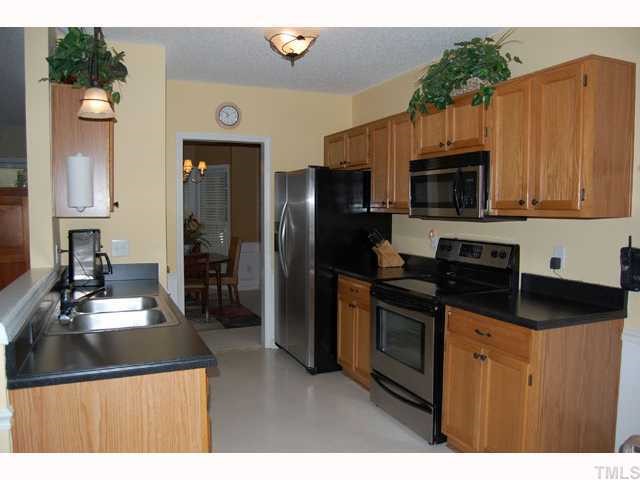 134 Solstice Circle Cary, NC 27513 - Photo 3 of 12 a kitchen with stainless steel appliances a stove microwave and refrigerator
