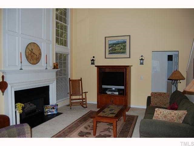 134 Solstice Circle Cary, NC 27513 - Photo 5 of 12 a living room with furniture a flat screen tv and a fireplace