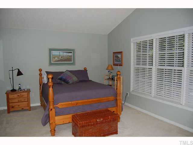 134 Solstice Circle Cary, NC 27513 - Photo 7 of 12 a bed sitting in a bedroom next to a window