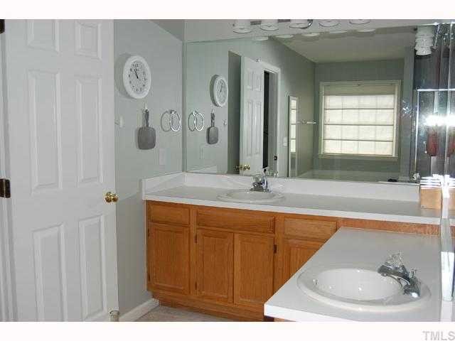 134 Solstice Circle Cary, NC 27513 - Photo 8 of 12 a bathroom with a sink and a mirror