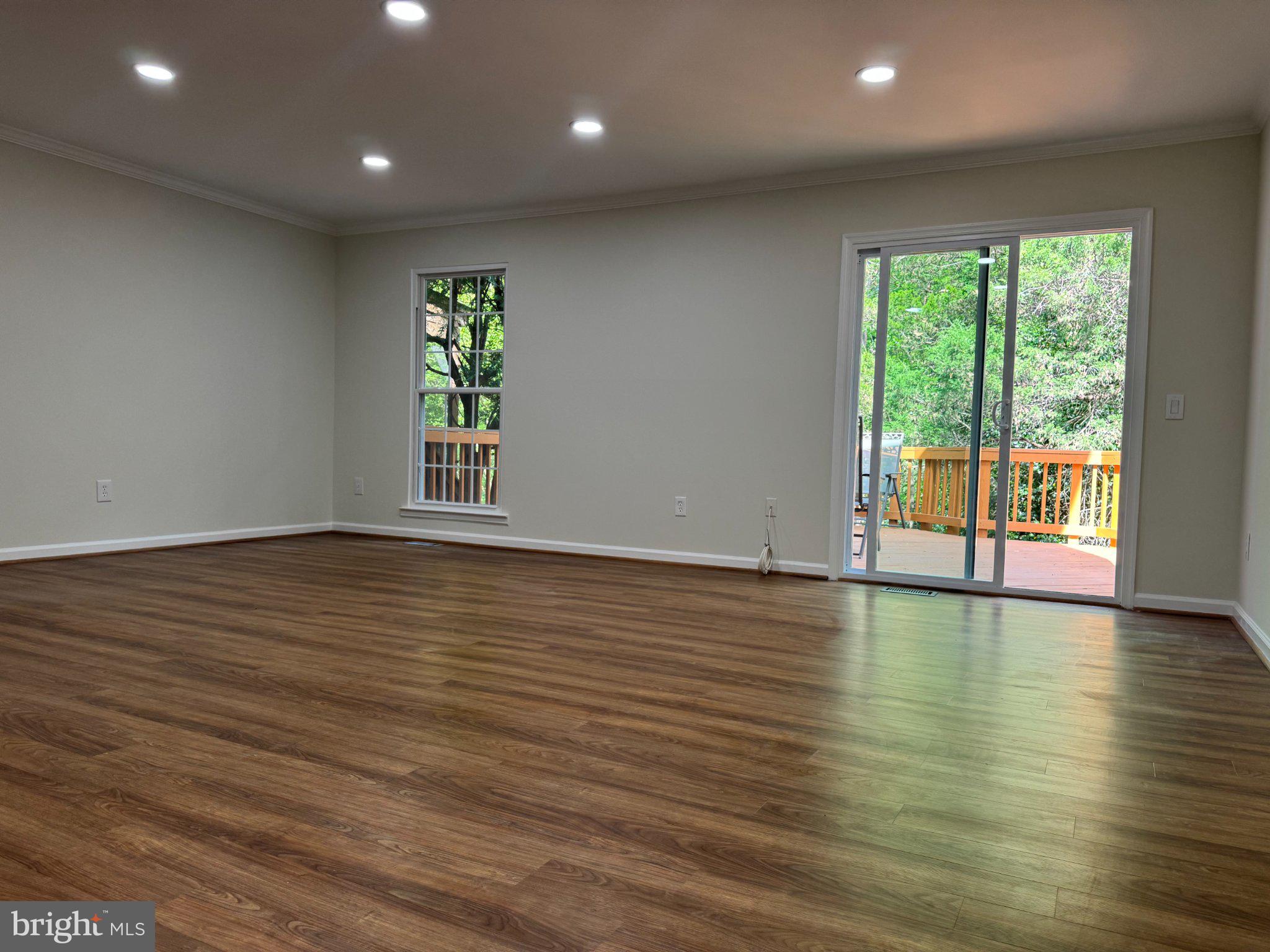 10542 Reed's Landing Circle Burke, VA 22015 - Photo 11 of 32 an empty room with wooden floor and windows