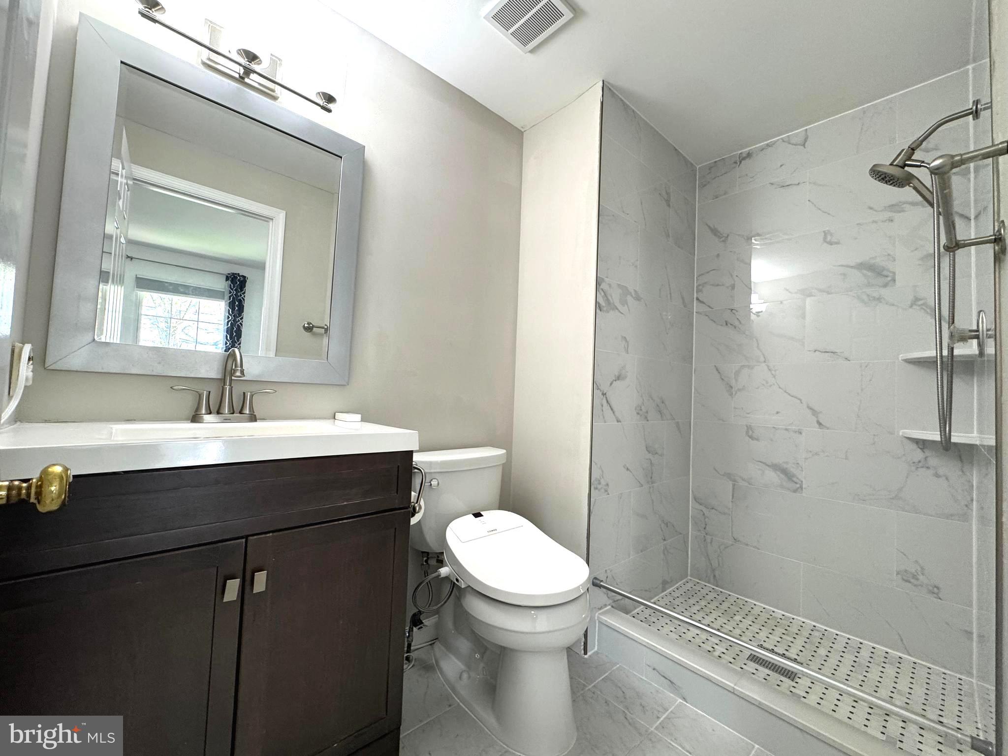 10542 Reed's Landing Circle Burke, VA 22015 - Photo 13 of 32 a bathroom with a sink a toilet and shower