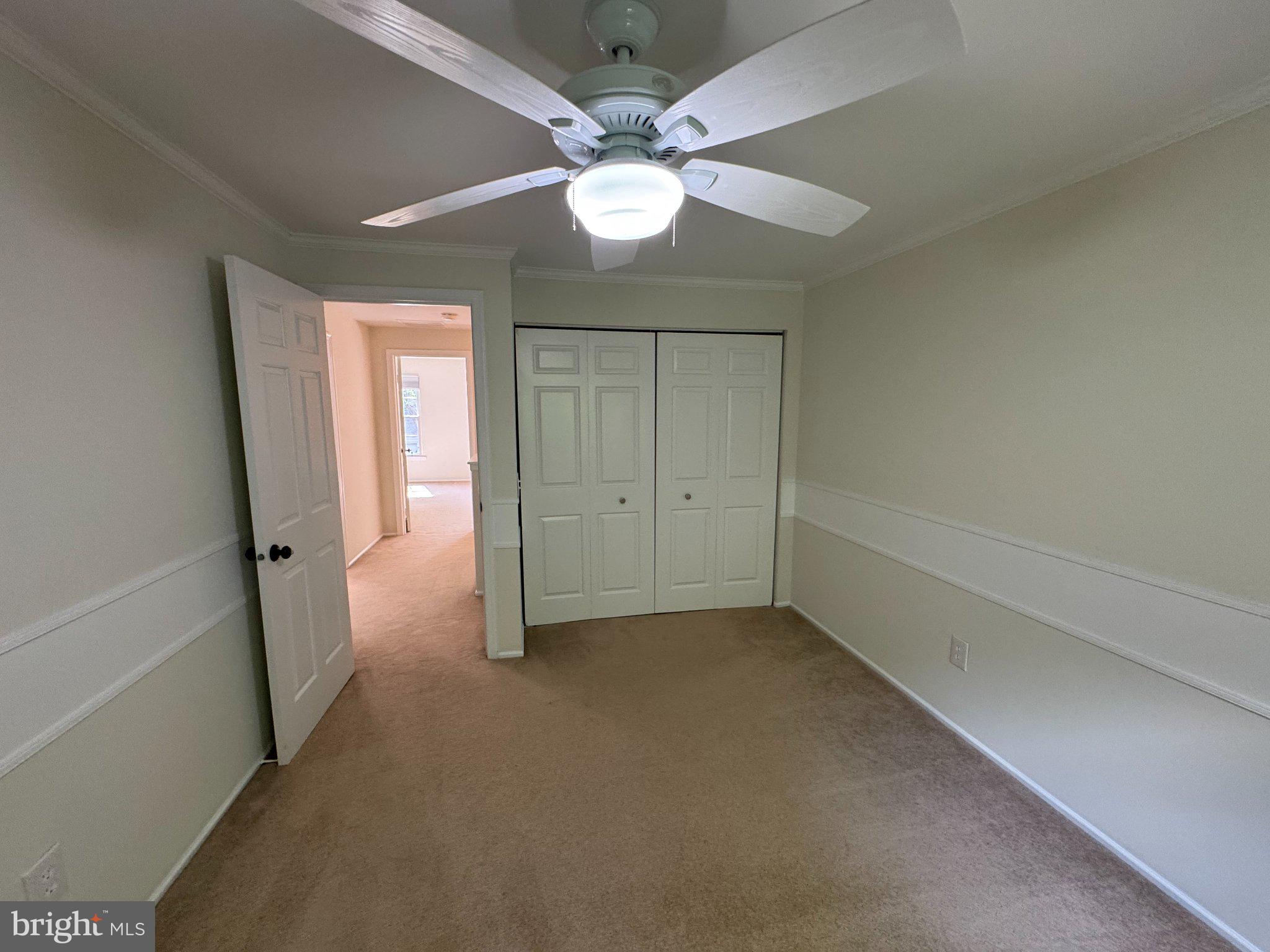 10542 Reed's Landing Circle Burke, VA 22015 - Photo 18 of 32 an empty room with chandelier fan and windows