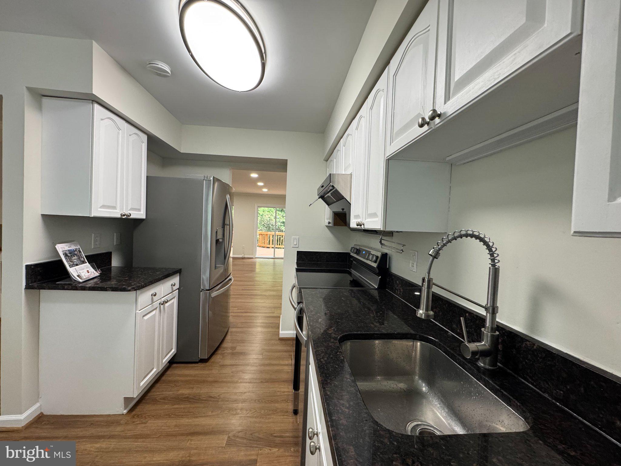 10542 Reed's Landing Circle Burke, VA 22015 - Photo 5 of 32 a kitchen with granite countertop a sink stainless steel appliances and cabinets