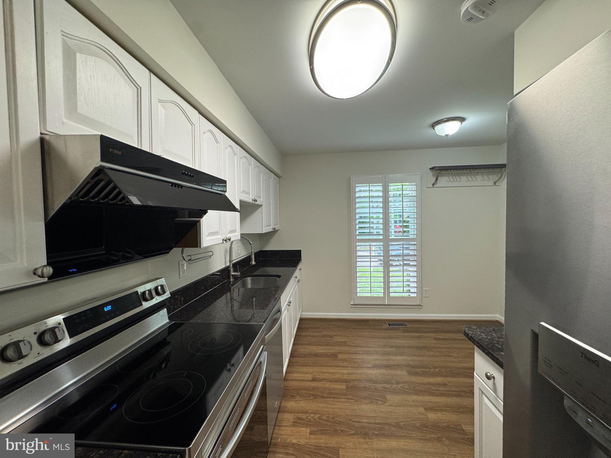 10542 Reed's Landing Circle Burke, VA 22015 - Photo 6 of 32 a kitchen with a stove and a microwave