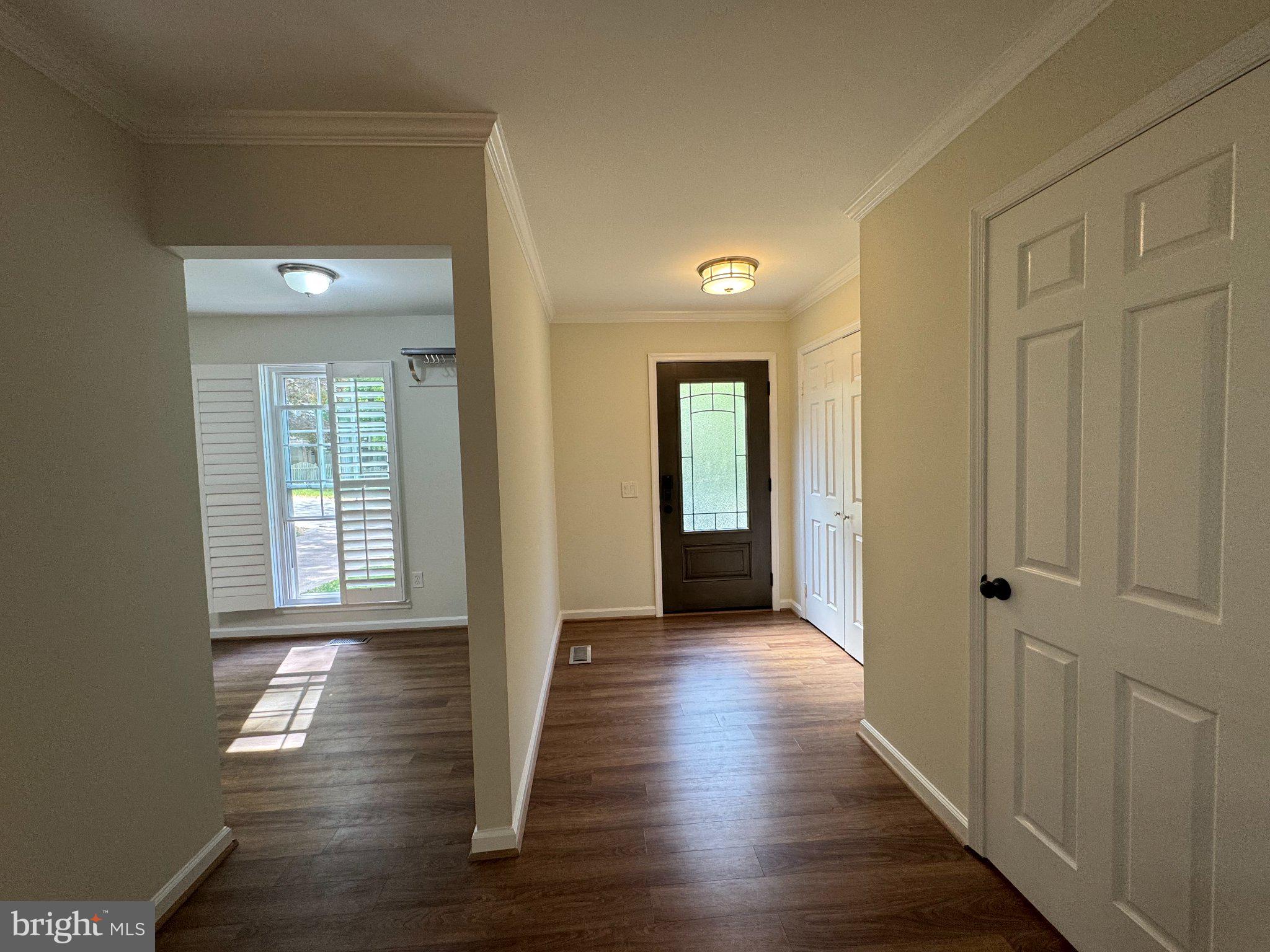 10542 Reed's Landing Circle Burke, VA 22015 - Photo 8 of 32 a view of a hallway with wooden floor and front door