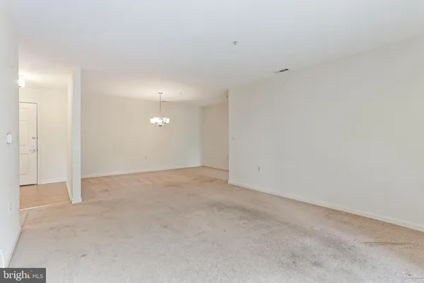 a view of a chandelier fan and refrigerator in a room