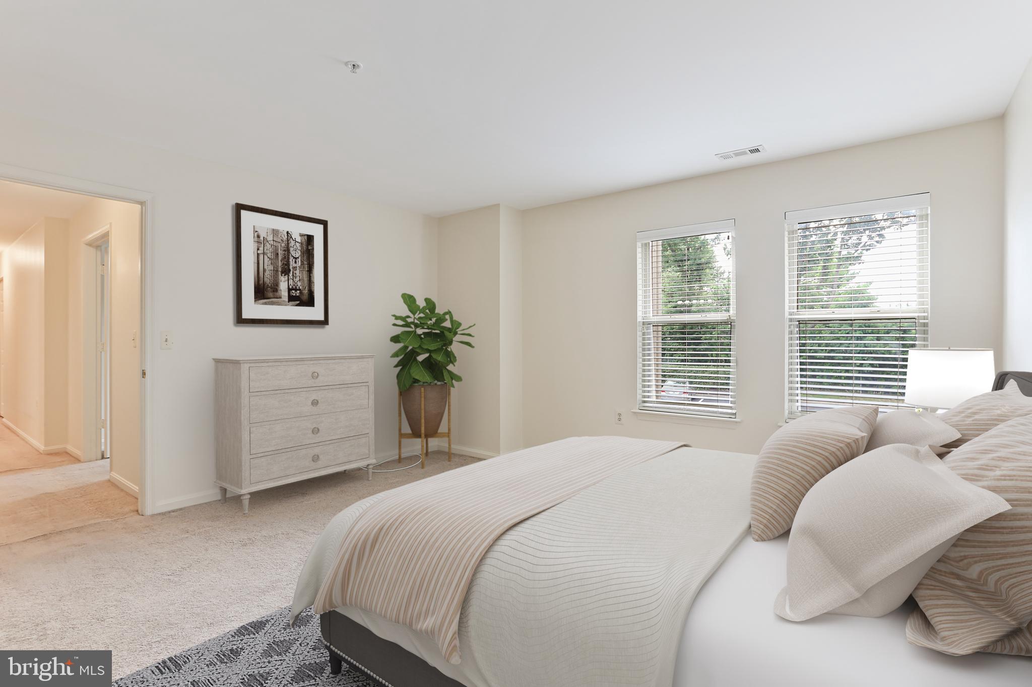 3907 Hannon Court, Unit 2A Baltimore, MD 21236 - Photo 15 of 34 a bedroom with a bed a couch and a window